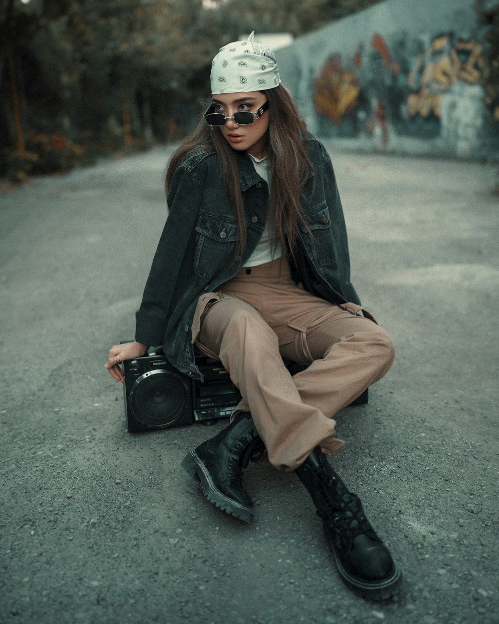 a woman sitting on the ground with a camera