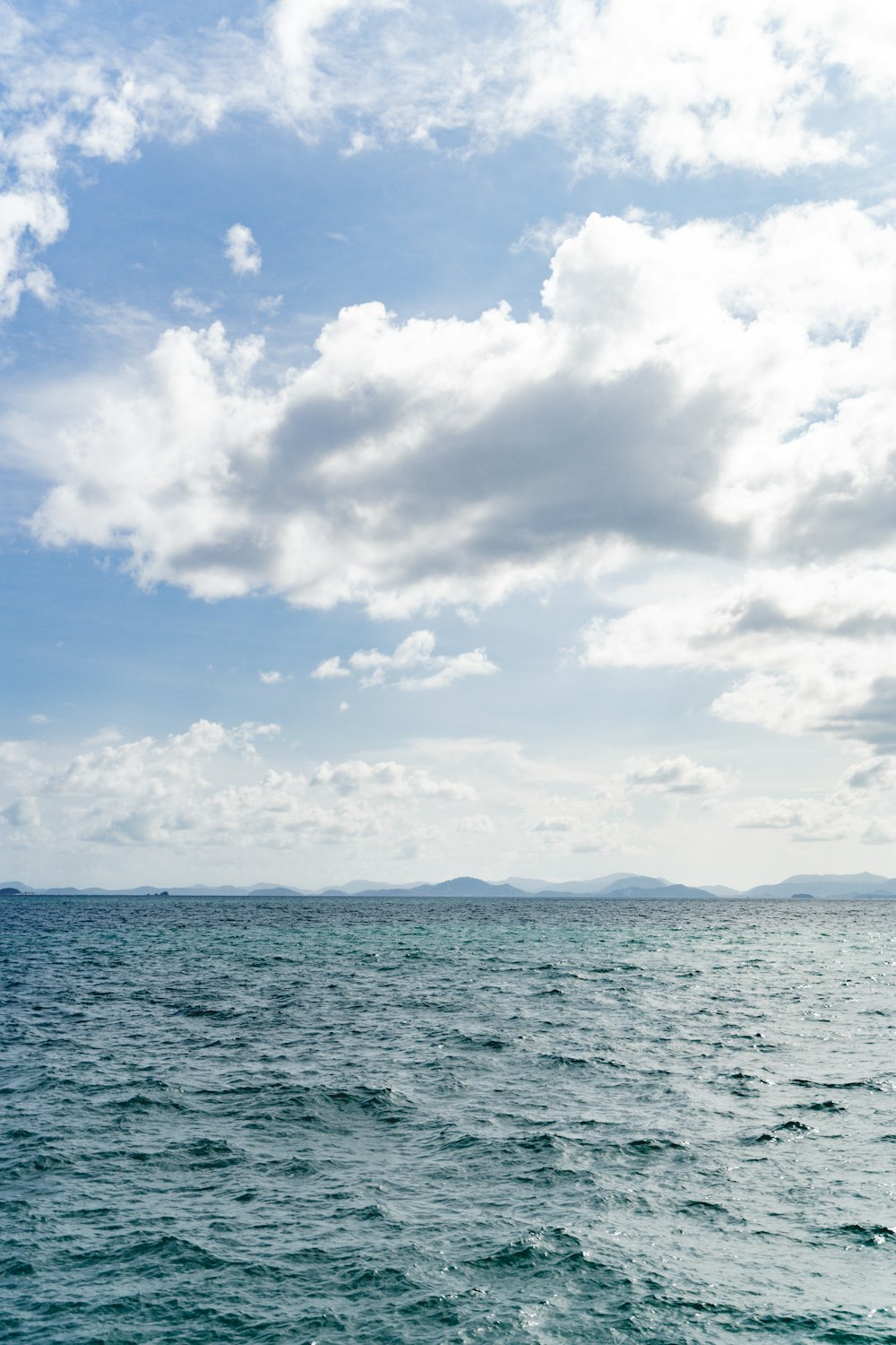 a large body of water under a cloudy sky