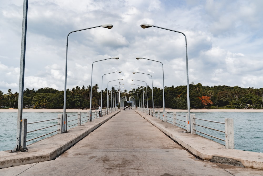 a long pier with street lights on each side