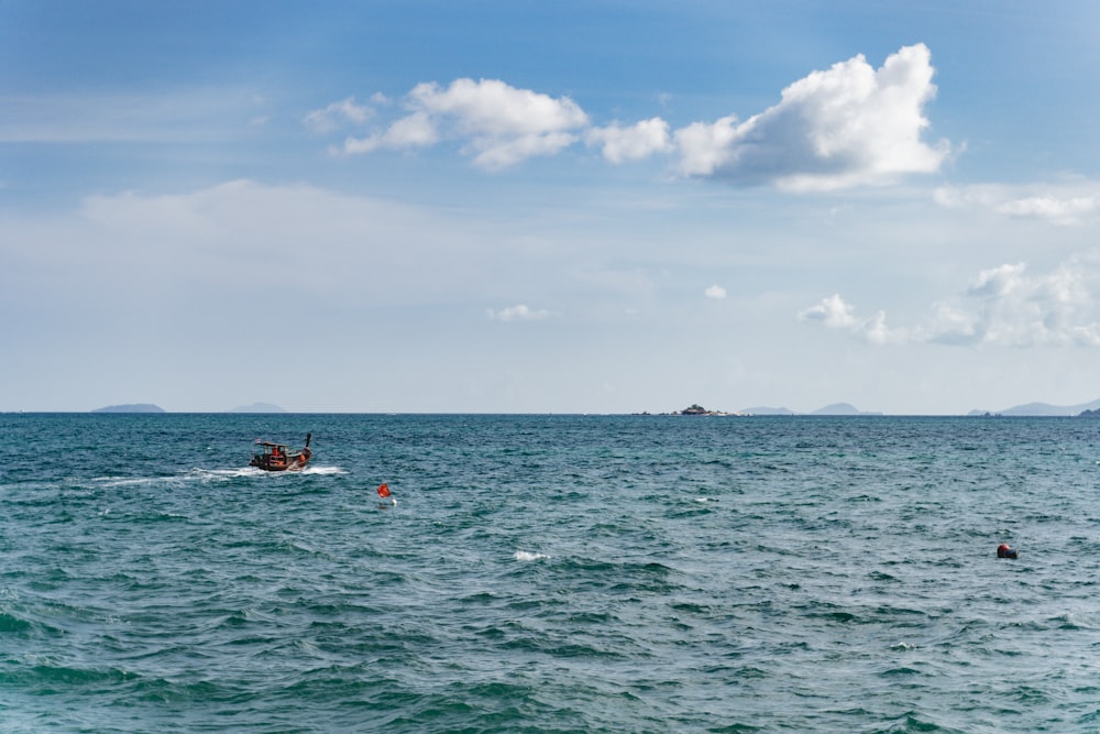 a small boat in the middle of a large body of water