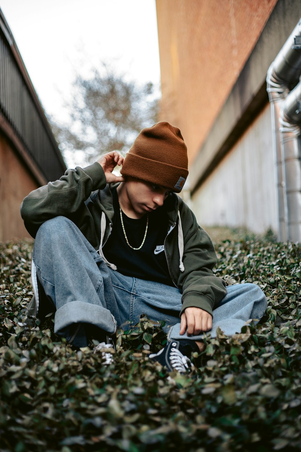 a person sitting on the ground with a hat on