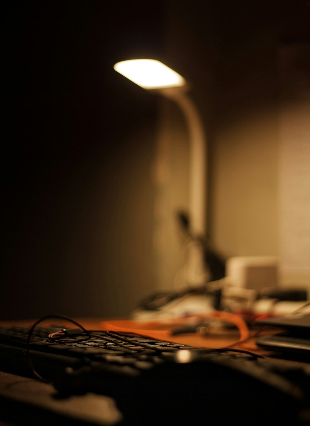 a computer keyboard sitting on top of a wooden desk