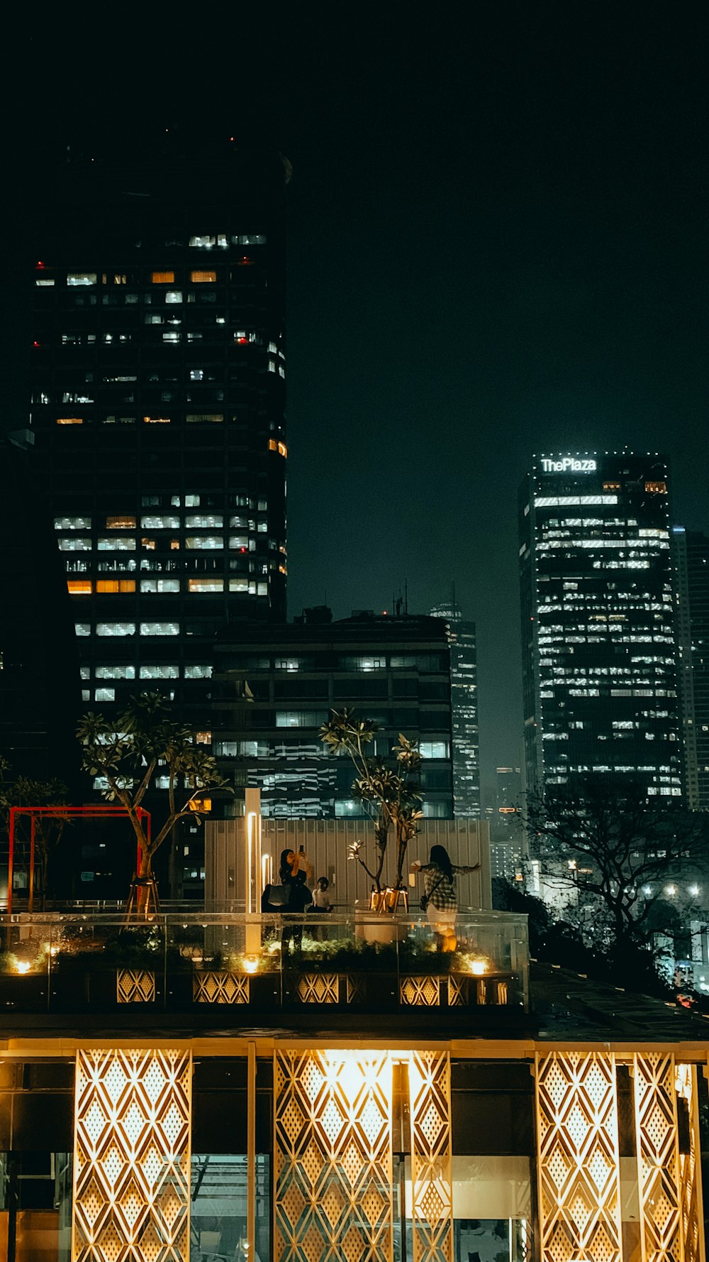 a night view of a city with tall buildings