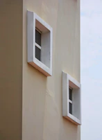Modern architectural window series with clean lines and soft cream framing.