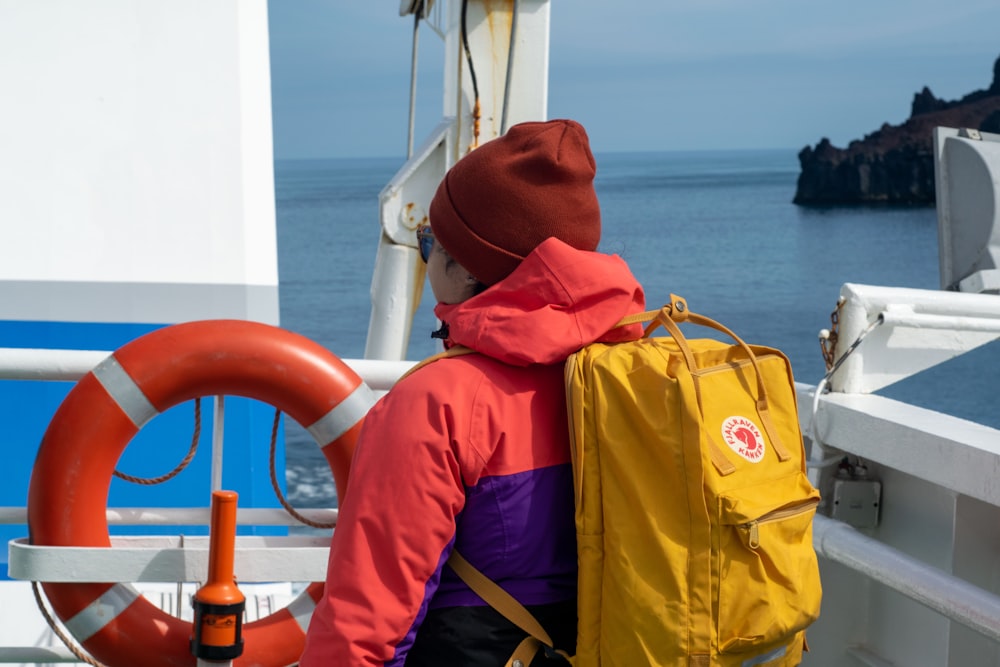 a person with a backpack on a boat