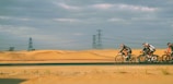 Cyclists riding through a scenic desert trail in Atacama.