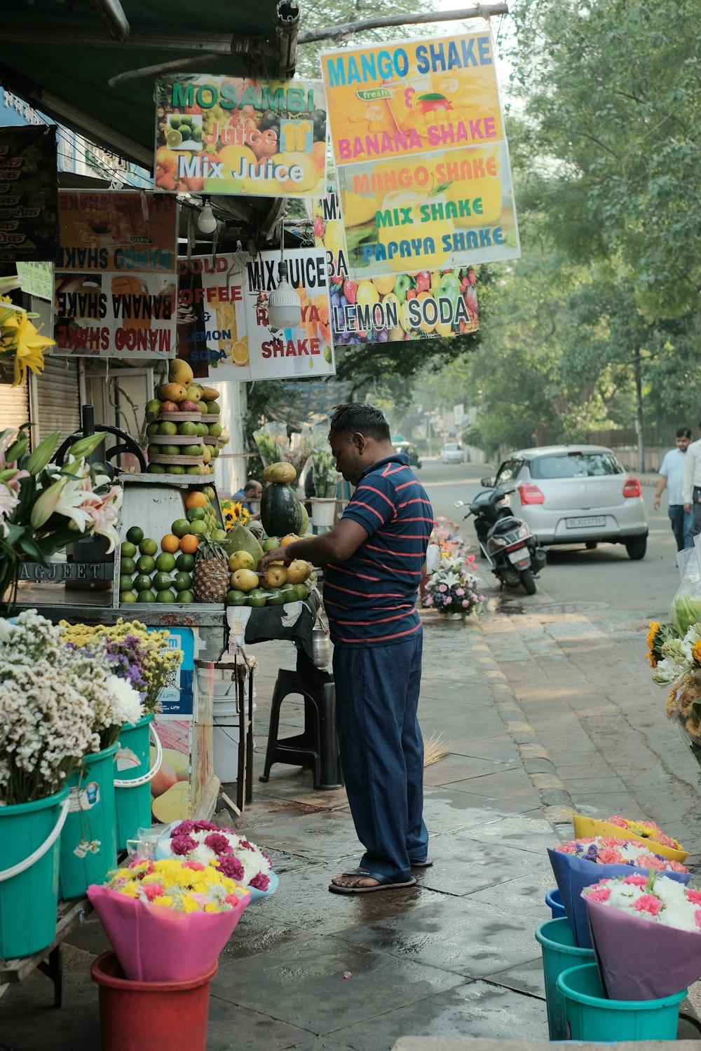 a man standing in front of a fruit stand