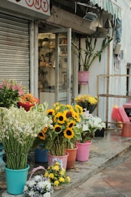 The storefront of blumen-jaeck on a sunny day, with colorful flowers displayed outside.