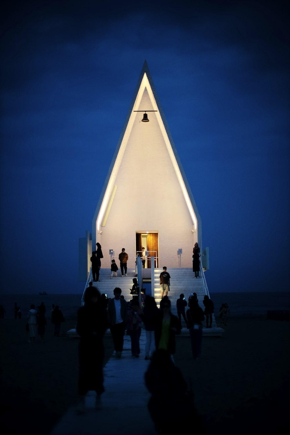 a group of people standing in front of a white building