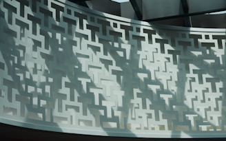 Decorative wall featuring intricate microperforated metal patterns.