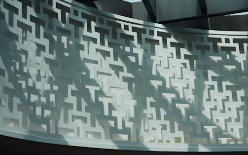 Decorative wall featuring intricate microperforated metal patterns.