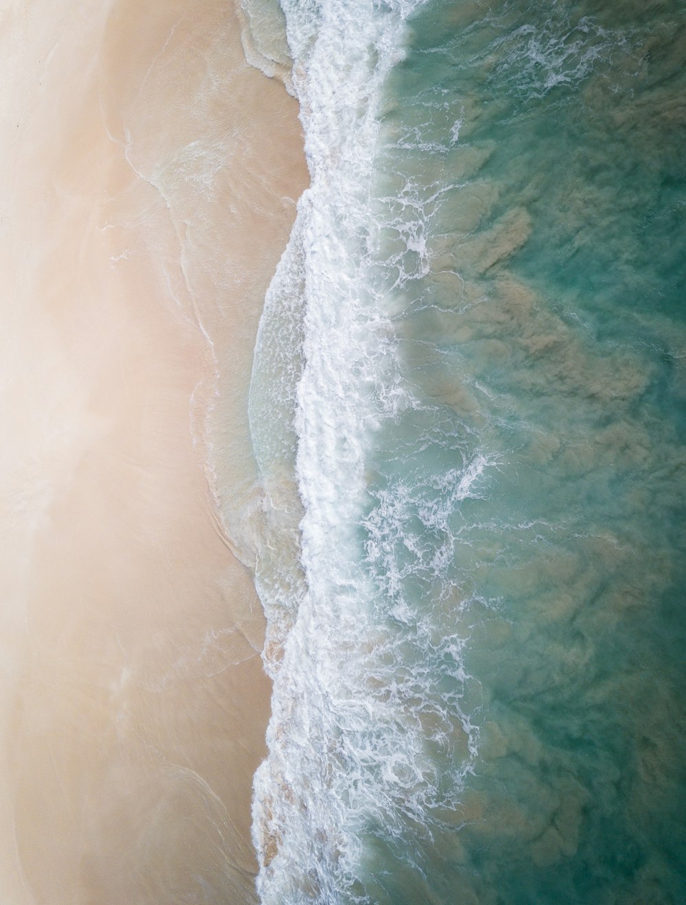 an aerial view of a beach and ocean