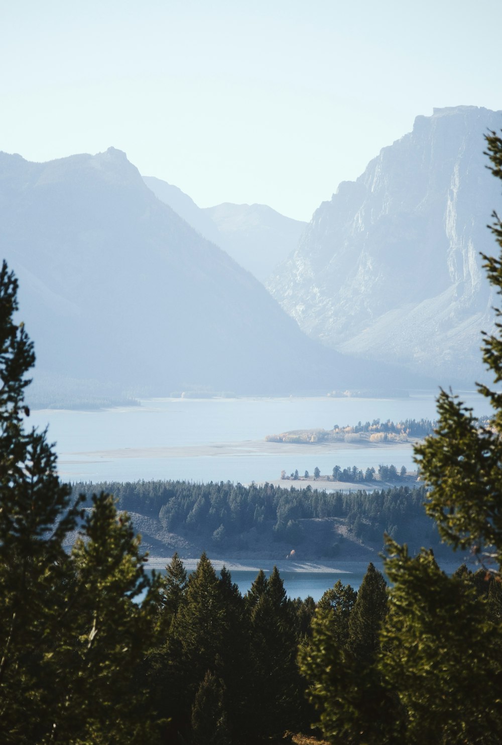 a view of a mountain range with a lake in the foreground