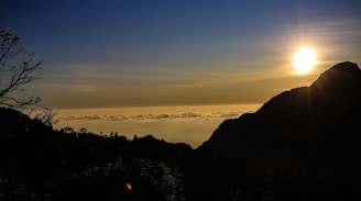 A scenic view of a travel destination with a sunset over the mountains.