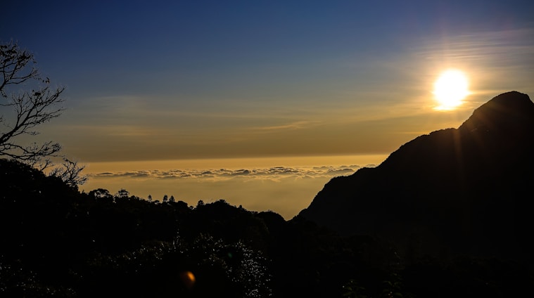 A scenic view of a travel destination with a sunset over the mountains.