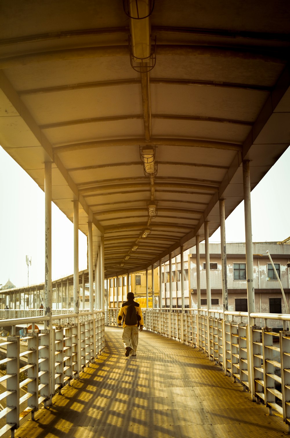 a person walking across a bridge over a body of water