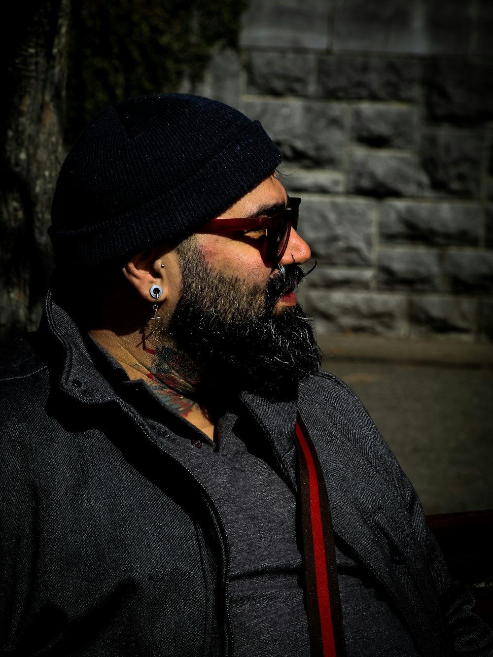 a man with a beard wearing sunglasses and a beanie