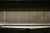 Stylish window blinds partially drawn, casting gentle shadows in a bright room.