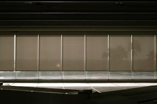 Cozy storefront of Persianas Uribe with sunlight filtering through elegant blinds.