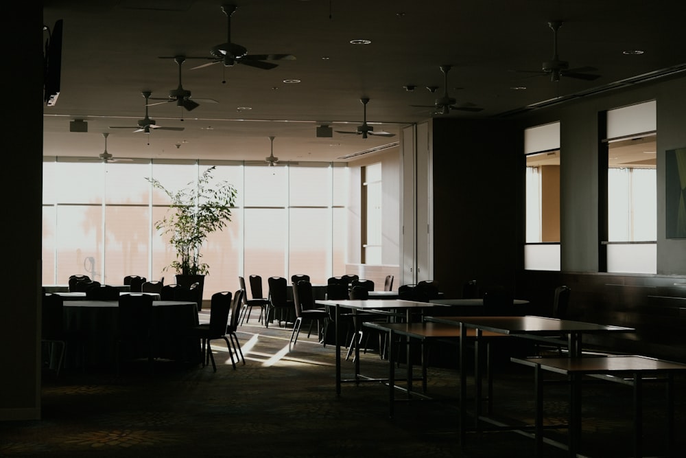 a dimly lit room with tables and chairs