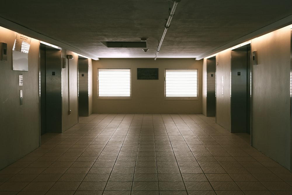 an empty room with several doors and windows