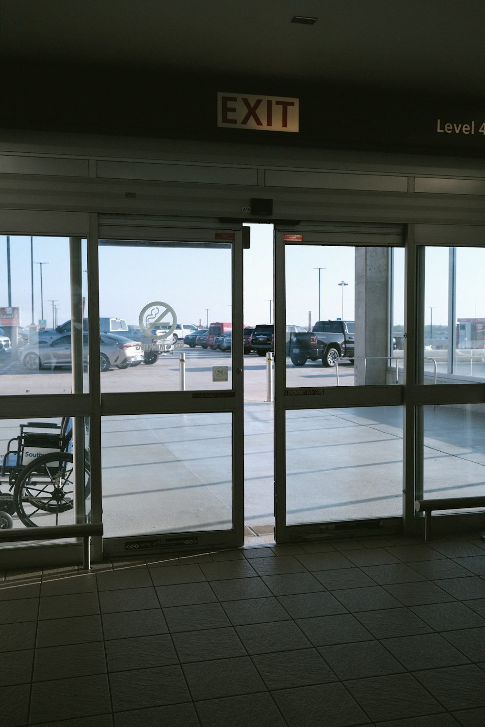 a wheelchair is parked in front of a large glass door