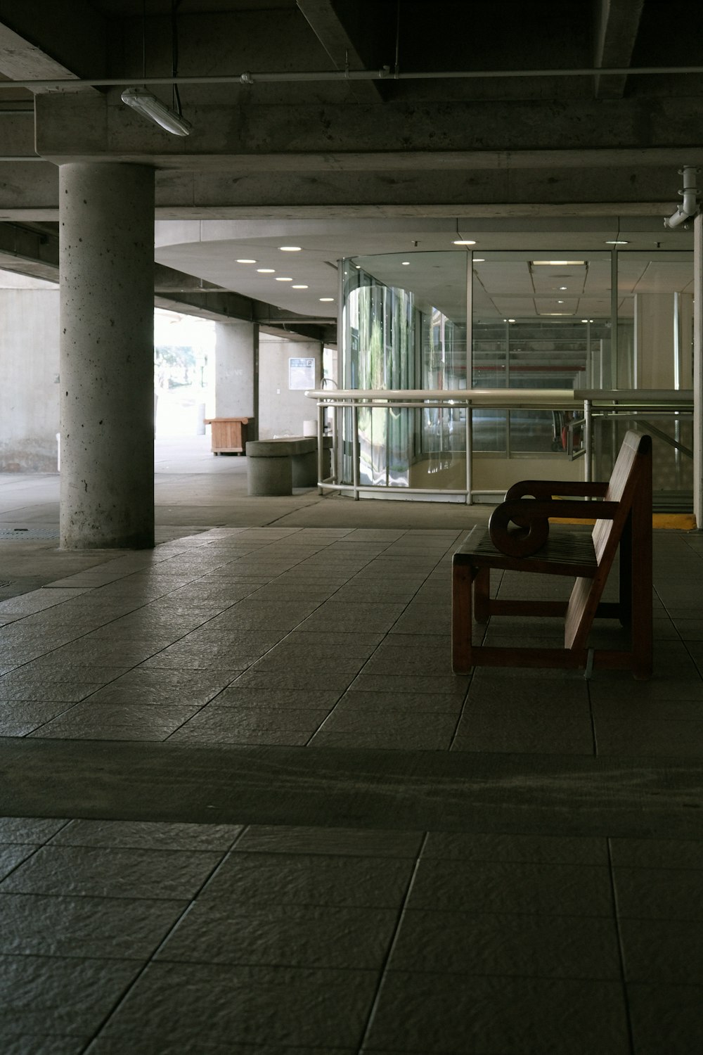 a bench sitting in the middle of an empty parking garage