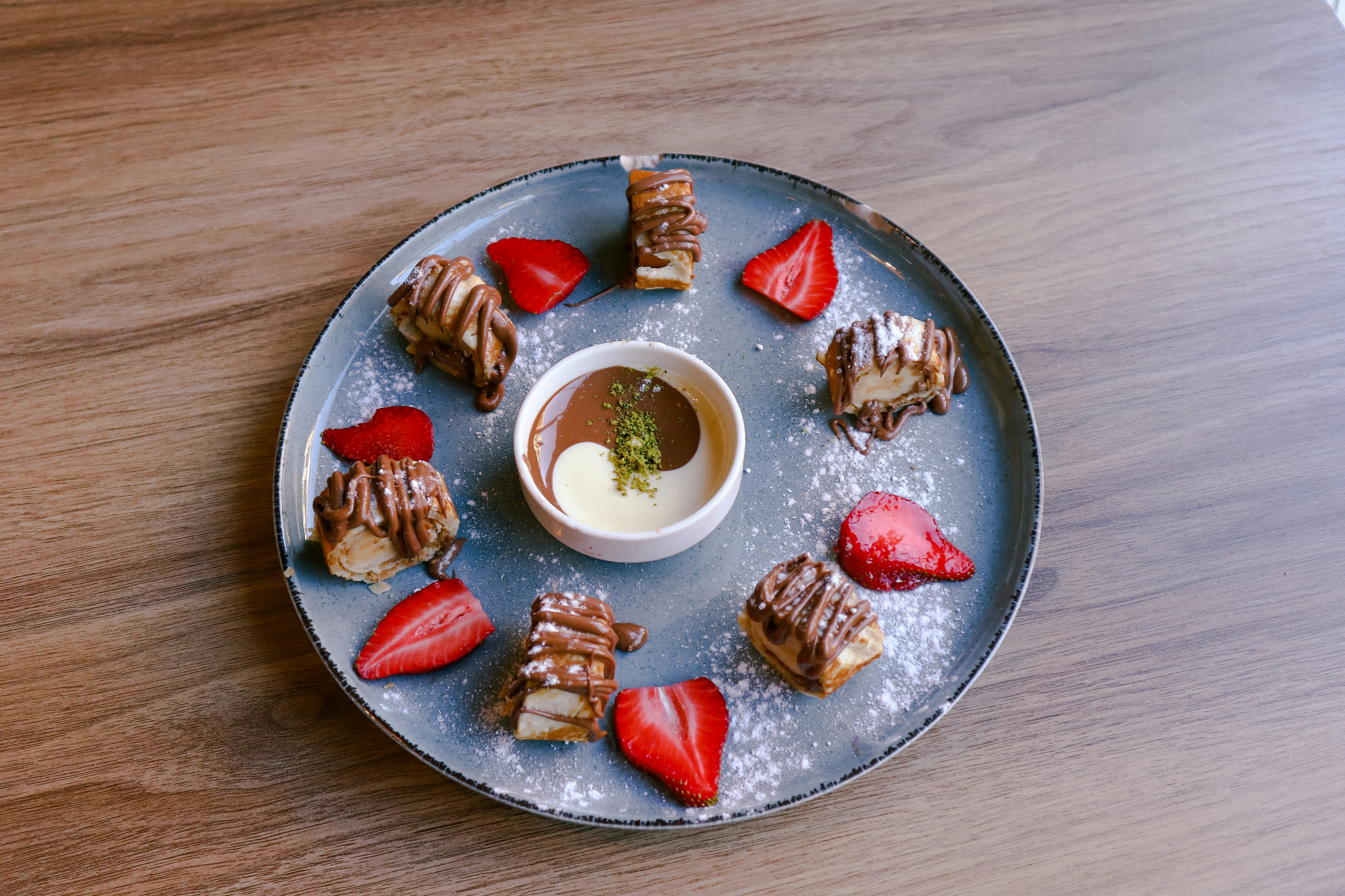 Plate of chocolate-dipped pastries with strawberries