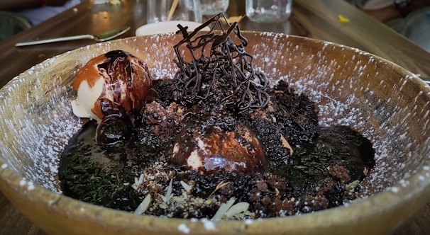 Rich chocolate gelato swirled with ribbons of dark fudge in a rustic bowl.