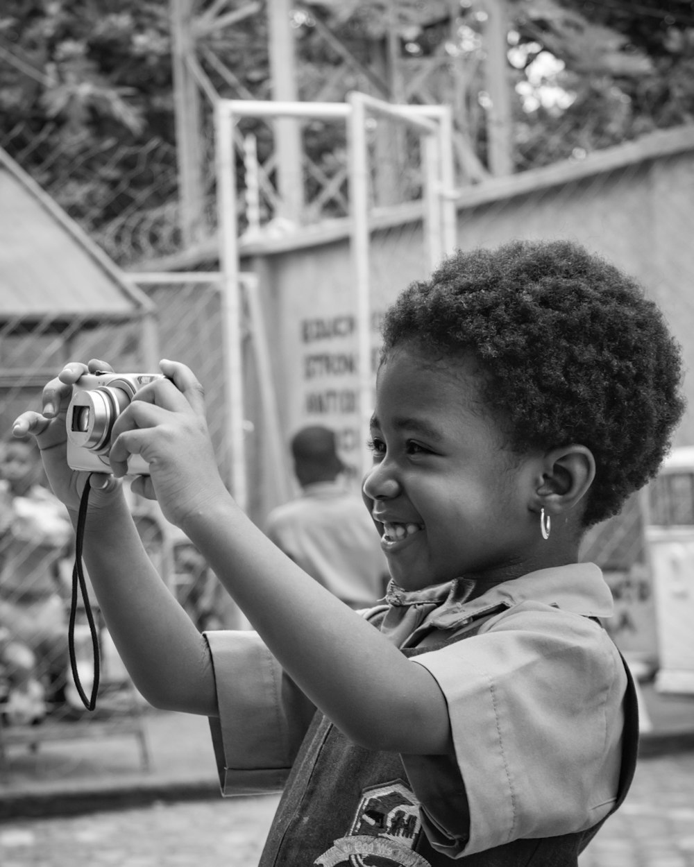 a young boy holding a camera up to take a picture
