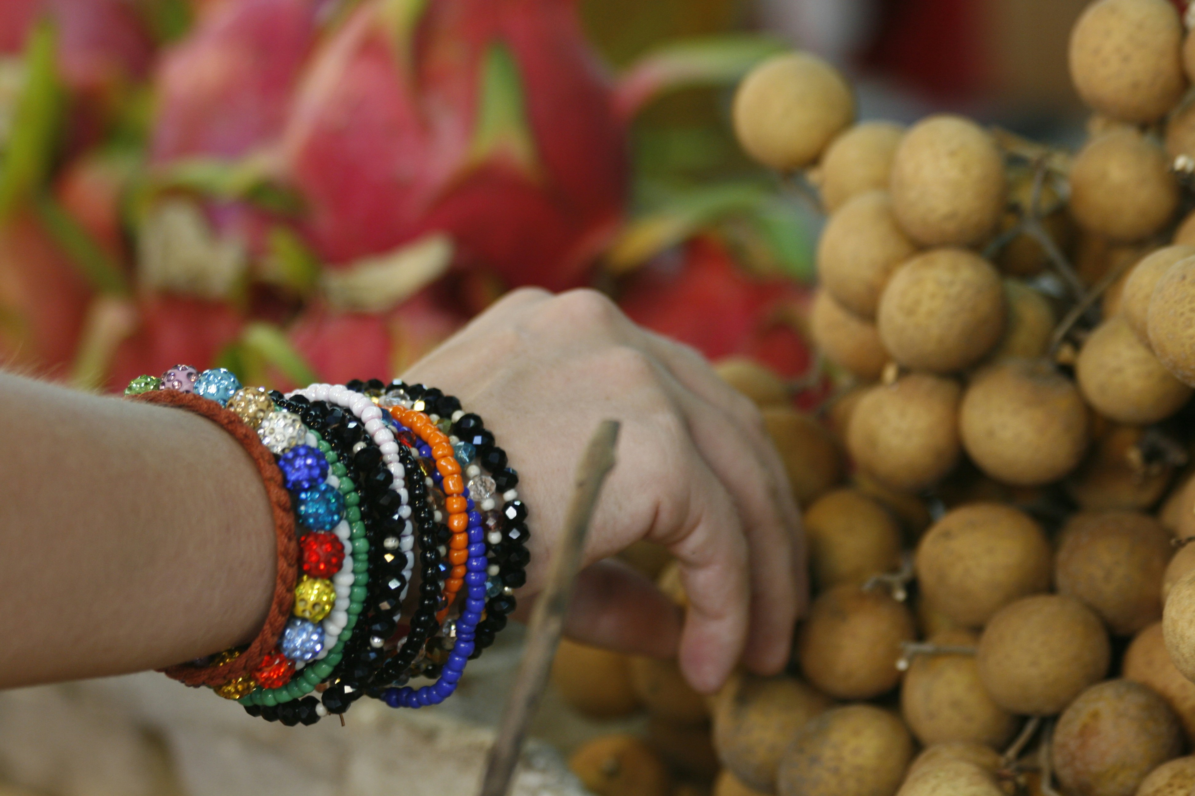 a close up of a person touching a bunch of fruit