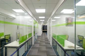 Modern office cabin setup showcasing glass partitions and aluminium frames creating private workspaces.