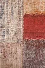 Close-up of a patch being expertly applied to a carpet damaged by pets.