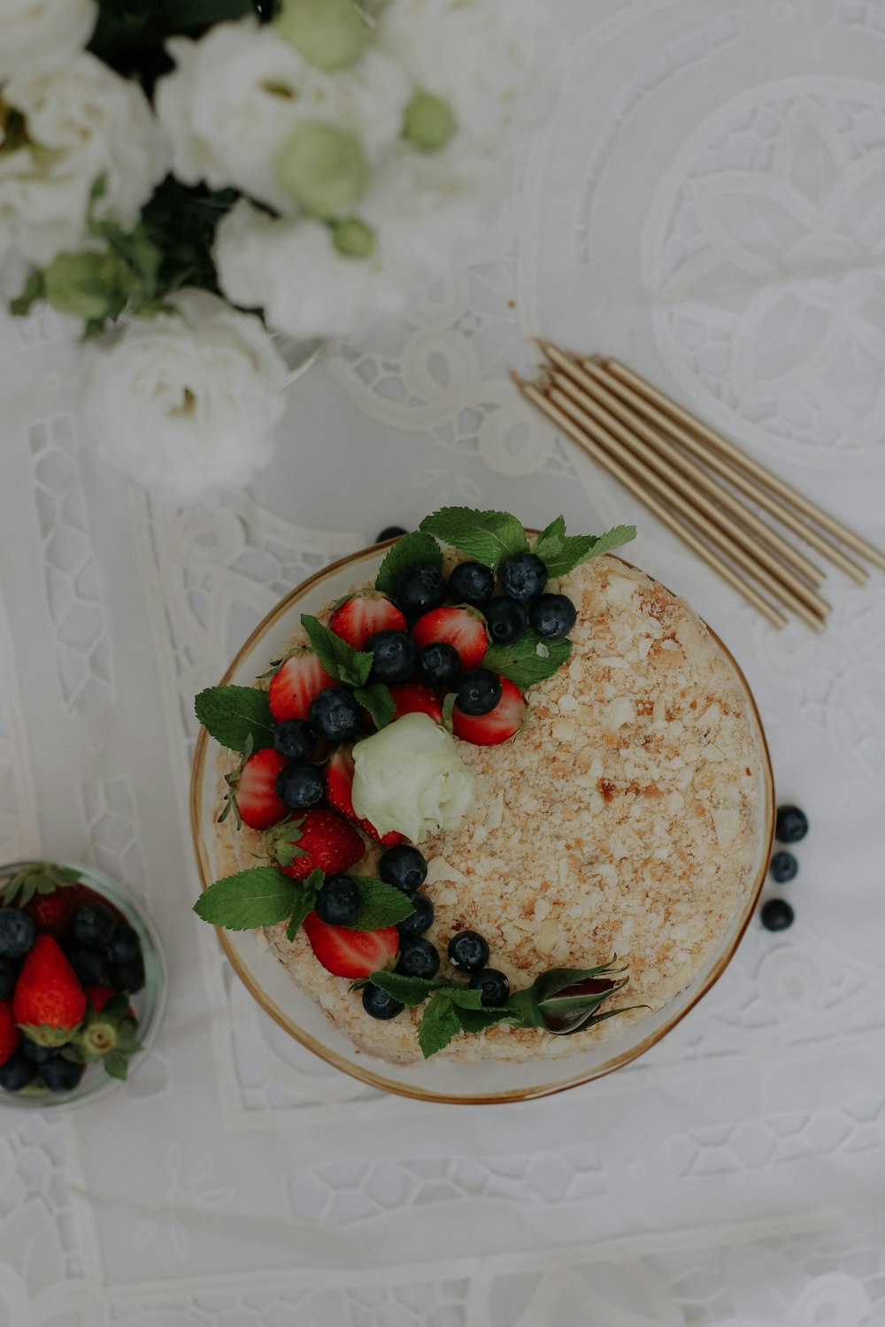 a plate of food with strawberries and blueberries on it