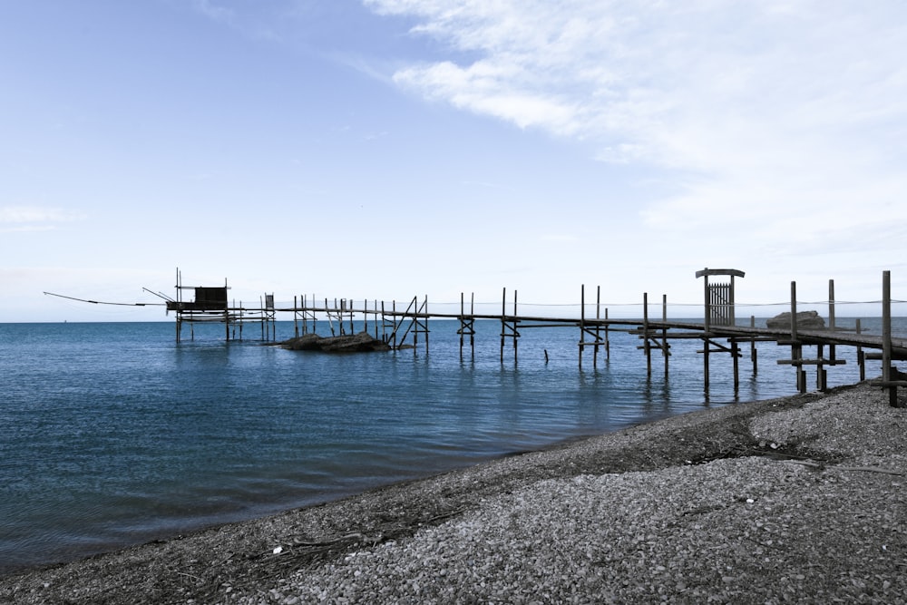 a boat is docked at the end of a pier