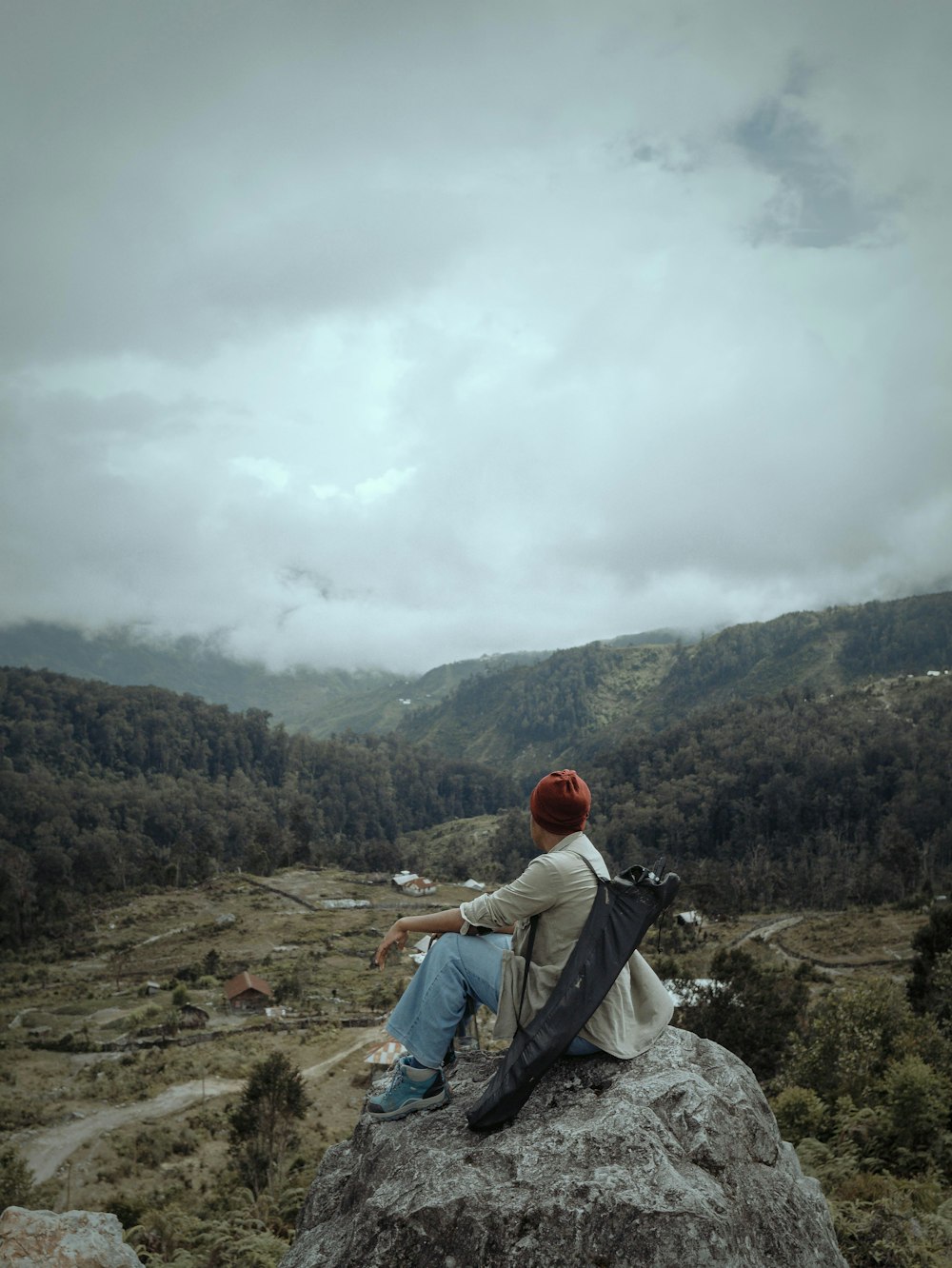 a person sitting on top of a large rock