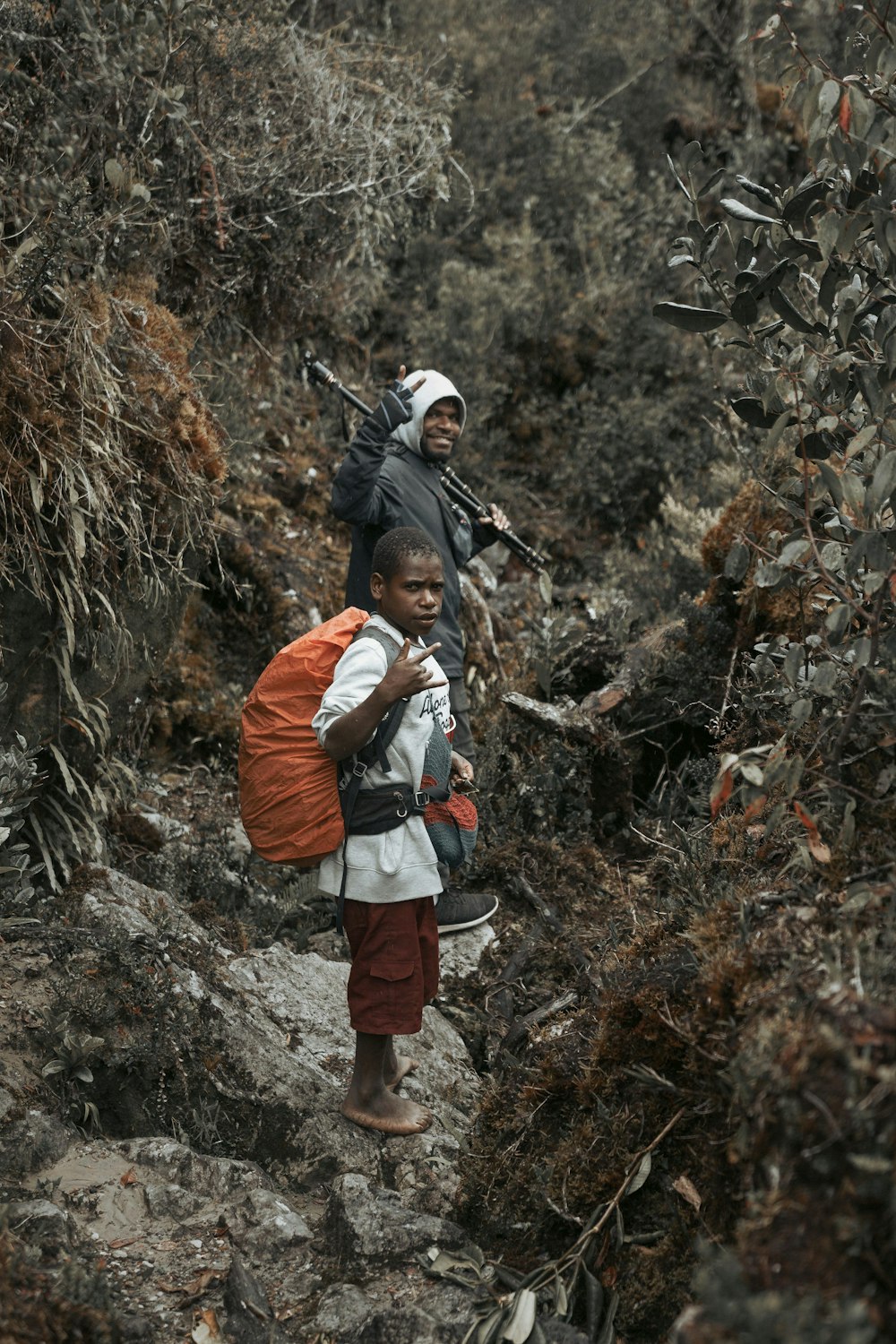 a couple of people that are walking up a hill