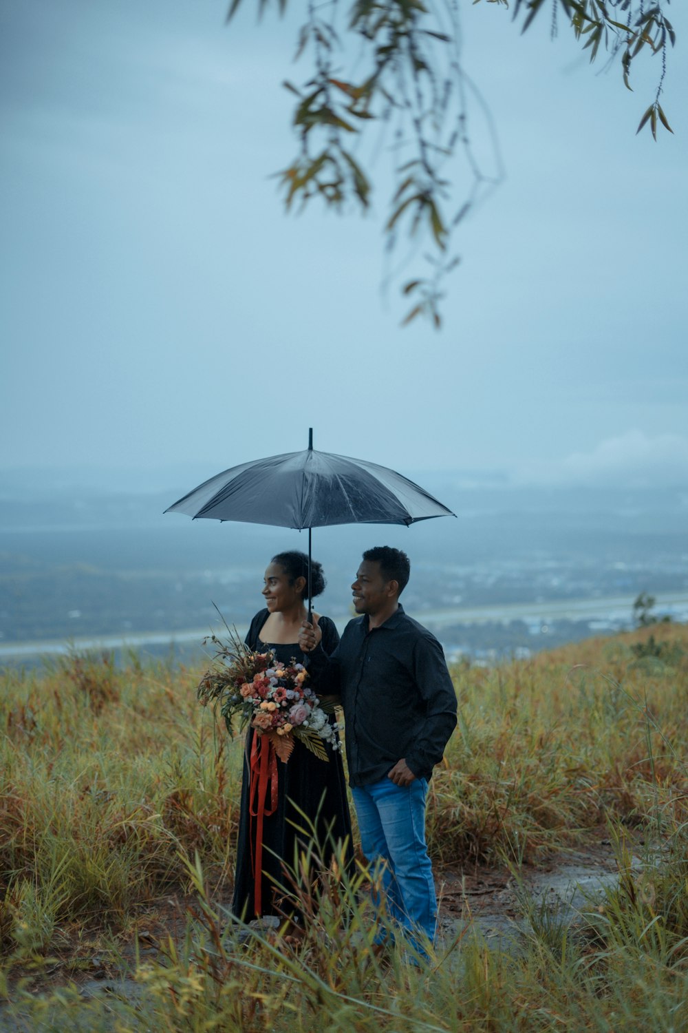 a man and a woman standing under an umbrella