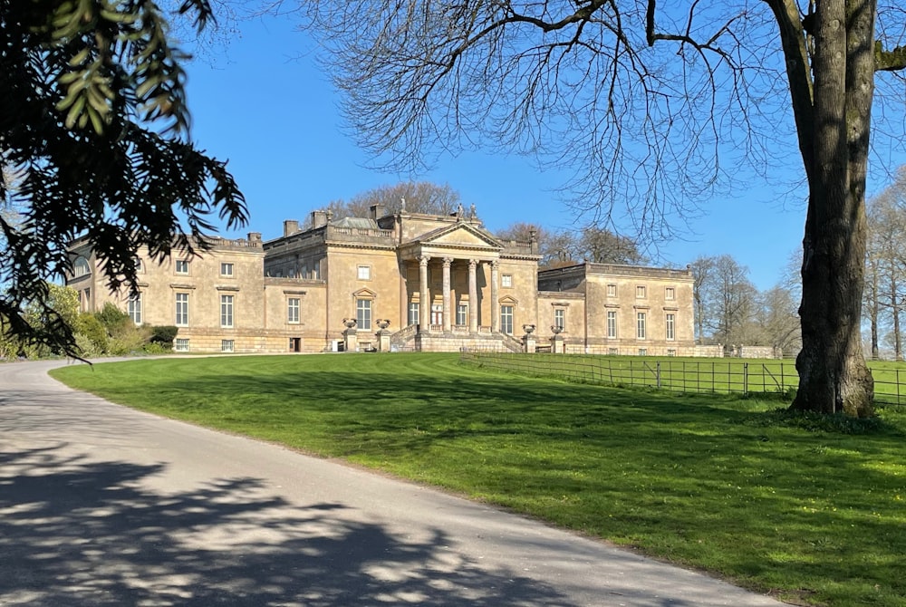 a large building sitting on top of a lush green field