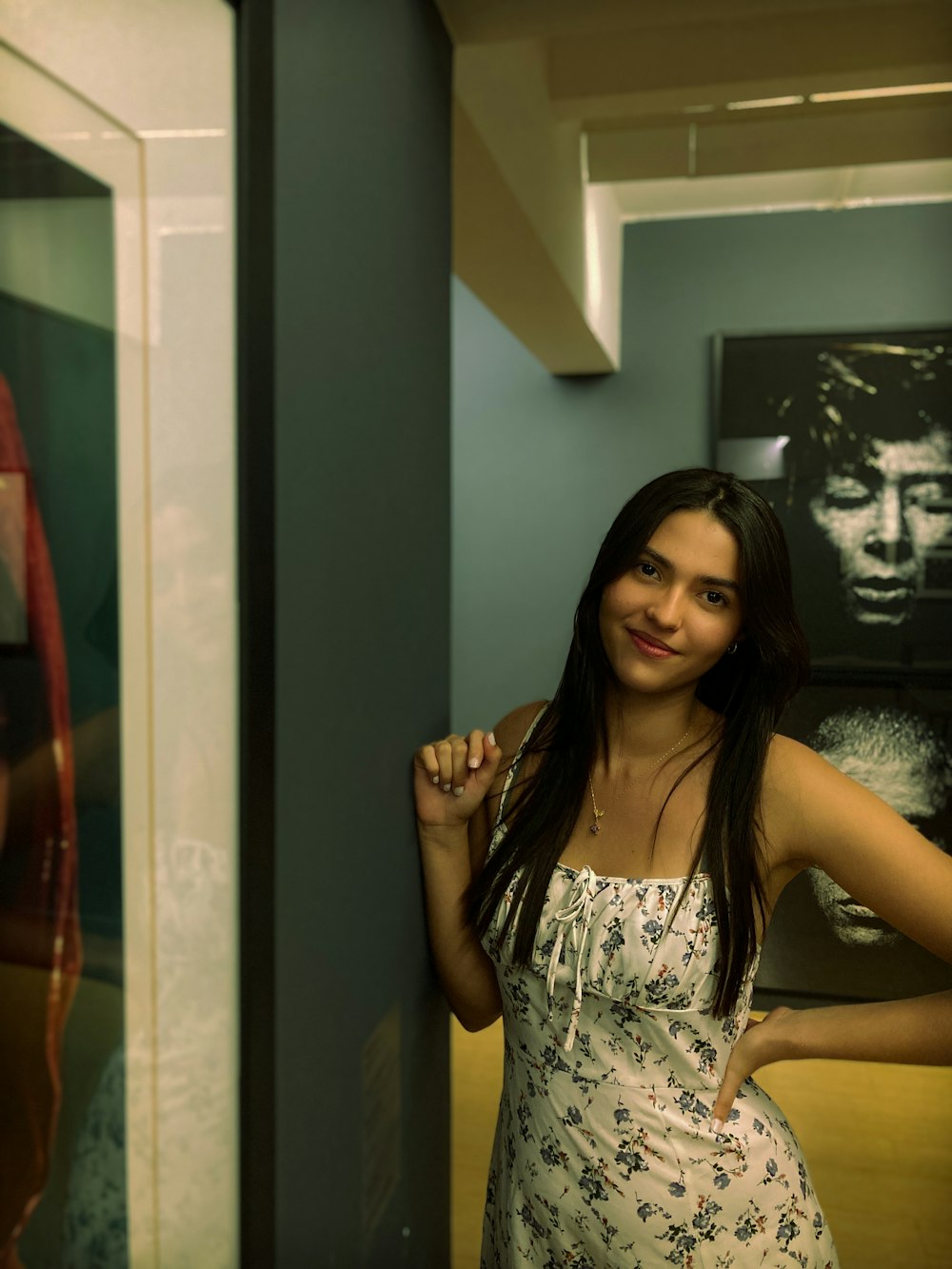 a woman standing in front of a mirror in a room