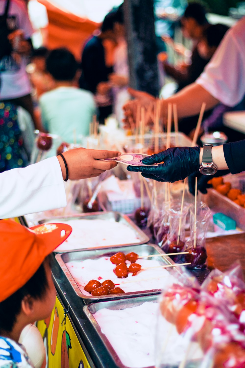 a person handing food to another person at a table