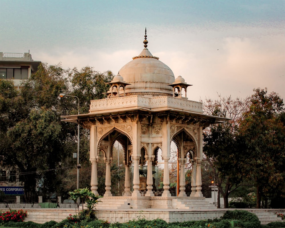 a gazebo in the middle of a park surrounded by trees