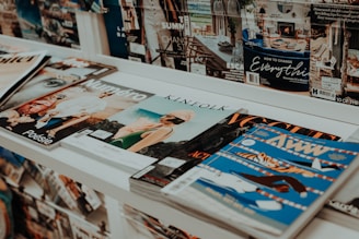 a bunch of magazines sitting on a shelf