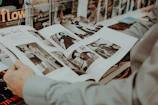 A vintage black-and-white photo of a 1940s federal agent examining medical files.