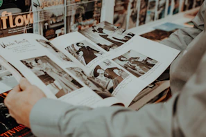 Guests flipping through a custom magazine featuring their photobooth pictures and candid moments