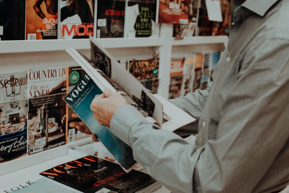 a man reading a book in a bookstore