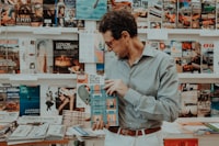 A man looking at a magazine in a store