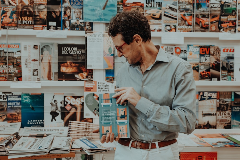 a man looking at a magazine in a store