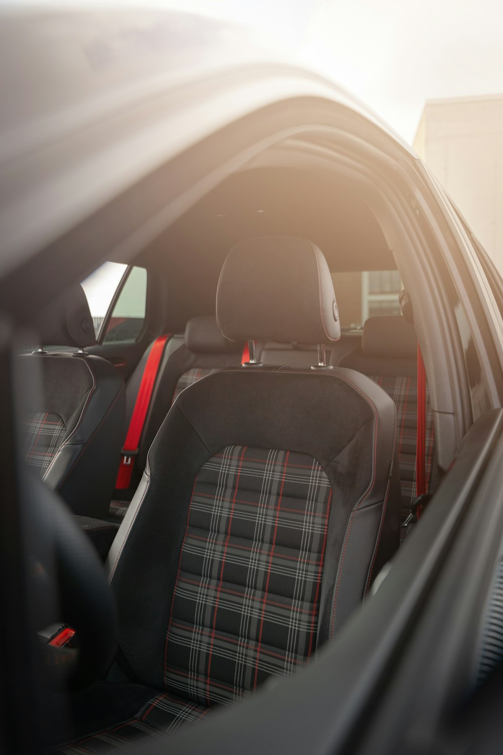 the interior of a car with a plaid seat cover