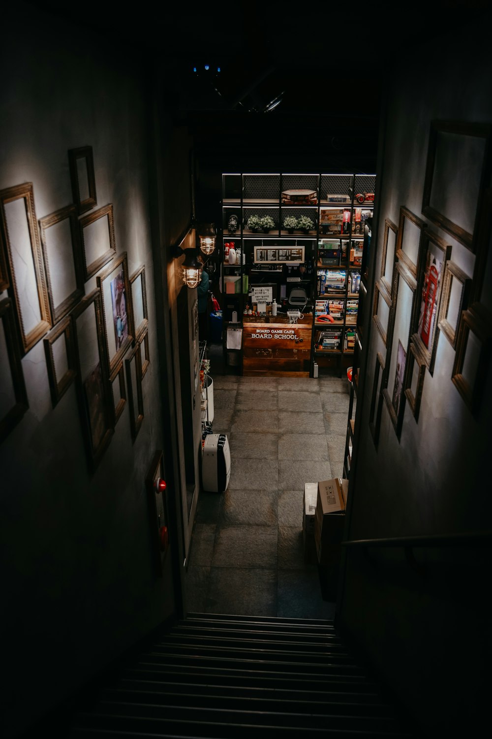 a stairway leading to a room with pictures on the wall